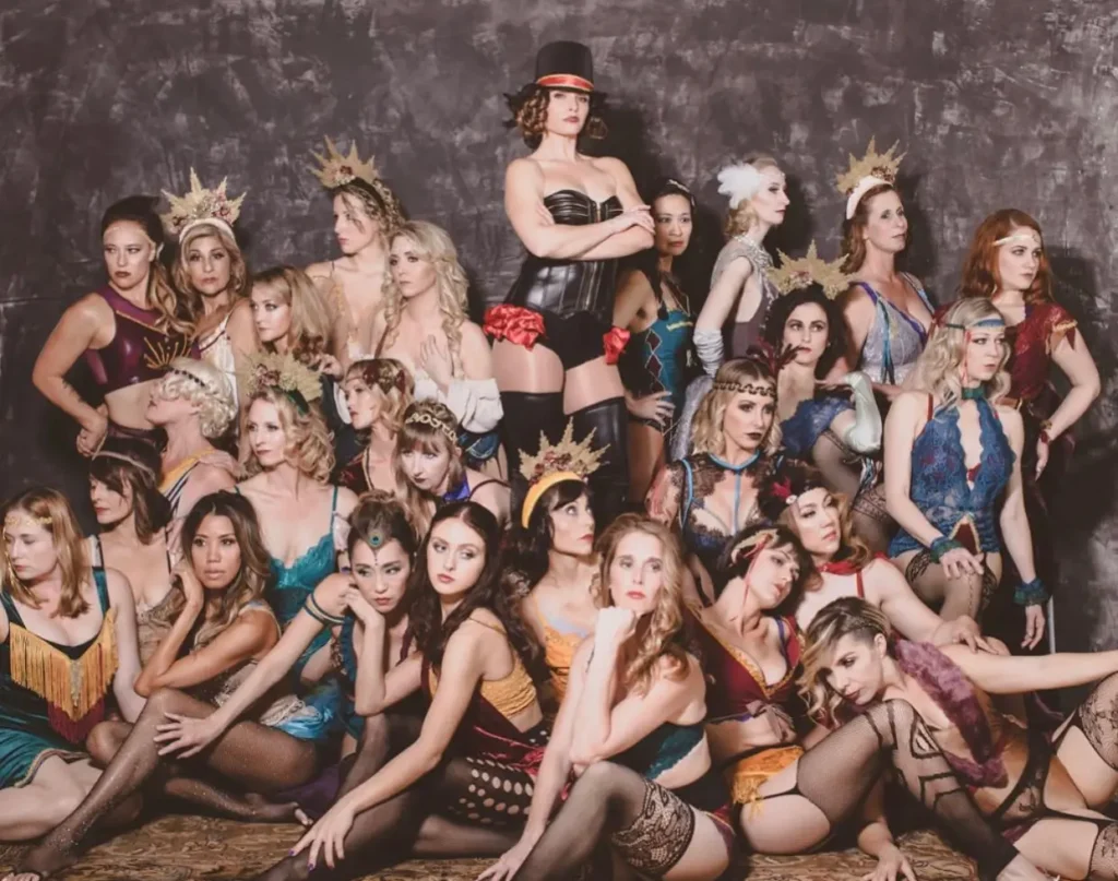 A glamorous group of young women pose for the camera, giving circus-themed bachelorette ideas.